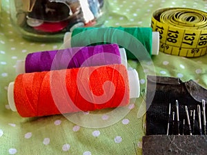 Sewing items - colorful thread, buttons, measuring tape, needles