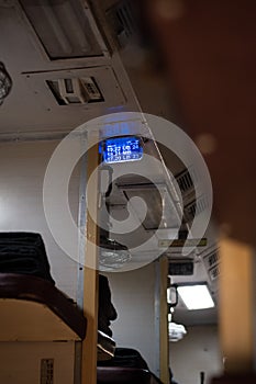 A picture of inside of an Indian train showing the seat numbers in blue LED board