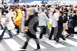 crowds of people crossing a street in Tokyo, Japan