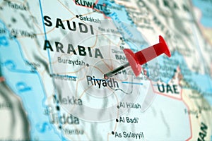 Picture of Kingdom of Saudi Arabia on a world map with a red pin on Riyadh the capital photo