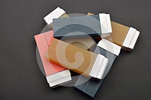 Picture of liposoluble wax cartridges for waxing on black backgroung photo