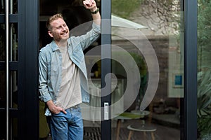 Portrait of tranquil caucasian man, relaxing, looking at his yard