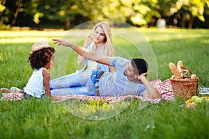 Picture of lovely couple with their daughter having picnic