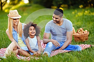 Picture of lovely couple with their daughter having picnic