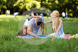 Picture of lovely couple with their daughter having picnic