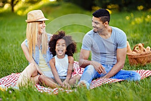 Picture of lovely couple with their daughter having picnic