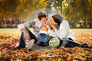 Picture of lovely family in autumn park, young parents with nice adorable kids playing outdoors, five cheerful person have fun on