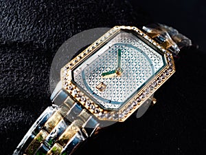 Picture of luxury woman wrist watch. Thus watch on a gold color and silver dial