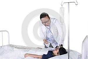 Pediatrician checks patient temperature on studio