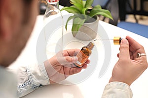 Picture of man drop medicine bottle holding in hand.