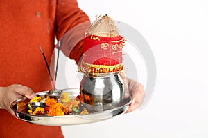 Picture of man hand is holding pooja thali for navratri festival