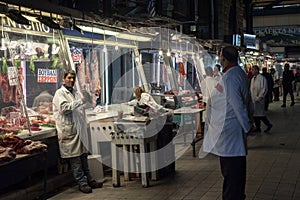 Butcher selling chickens and various other meats in the public market of Athens, Dimotiki agora