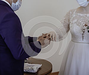 Picture of man and woman with bridal bouquet. Married couple holding hands, ceremony wedding day. Newly wed couple& x27;s