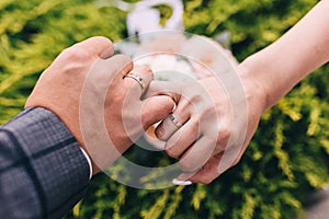 Picture of man and woman with wedding ring.Young married couple holding hands, ceremony wedding day. Newly wed couple`s hands wit