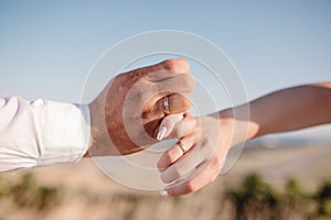 Picture of man and woman with wedding ring.Young married couple holding hands, ceremony wedding day. Newly wed couple`s