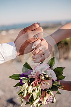 Picture of man and woman with wedding ring.Young married couple holding hands, ceremony wedding day. Newly wed couple`s