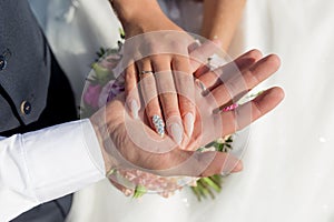 Picture of man and woman with wedding ring.Young married couple holding hands, ceremony wedding day. Newly wed couple`s hands wit