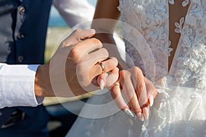 Picture of man and woman with wedding ring.Young married couple holding hands, ceremony wedding day. Newly wed couple`s hands wit