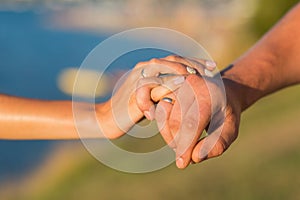 Picture of man and woman with wedding ring.Young married couple holding hands, ceremony wedding day. Newly wed couple`s hands wit