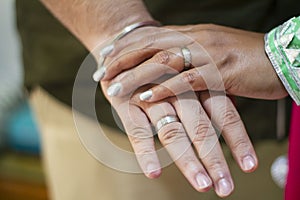 Picture of man and woman with wedding ring.Young married couple holding hands, ceremony wedding day. Newly wed couple`s hands wit