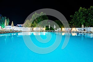 Picture of marvelous pool in seaside hotel at night.