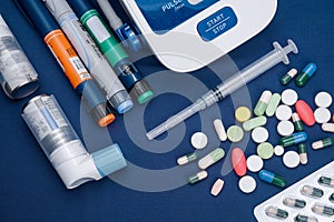 Picture of medical drugs pills, sryinge, insulin pen, automatic blood presure monitor device and atshma inhaler