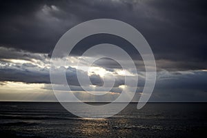 Morning light through the spring clouds at the Mediterranean sea photo