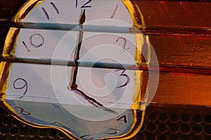 A picture of melting timepiece on a bench.