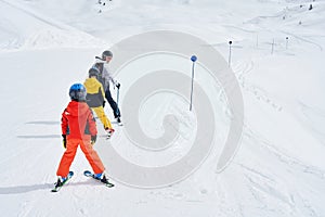 Picture of mother teach skiing her kids in Madonna di Campiglio