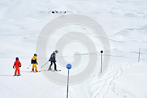 Picture of mother teach skiing her kids in Madonna di Campiglio