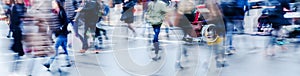 Wintry street scene in the city with people crossing a street