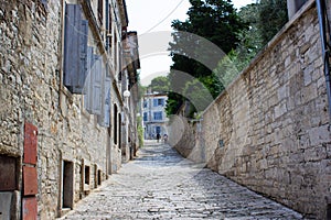 Picture of a narrow colorful stone street in the old town of Pula, Croatia, with steps at the background