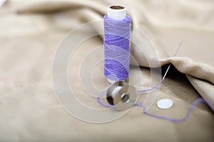 Picture of needle attached in cloth with Purple Sewing thread and bobbin