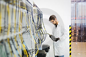 Picture of network technician testing modems in factory