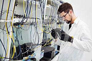 Picture of network technician testing modems in factory