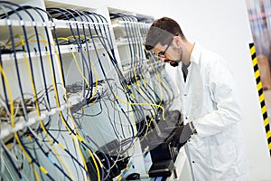 Picture of network technician testing modems in factory