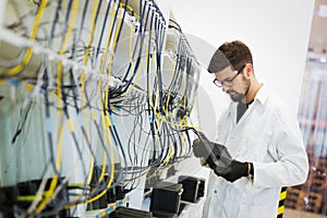 Picture of network technician testing modems in factory