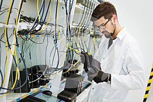 Picture of network technician testing modems in factory