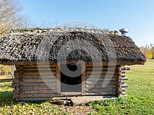 Picture with old log house and interesting roof mounts