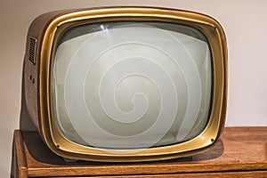 Picture of old vintage tv on the wooden shelf.