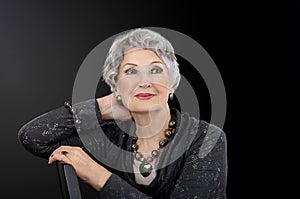 Picture of older woman posing with tiger iron eye jewelry set