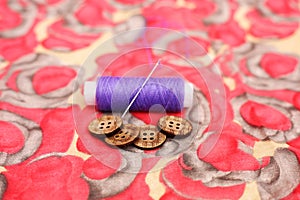 Picture of one purple thread and button