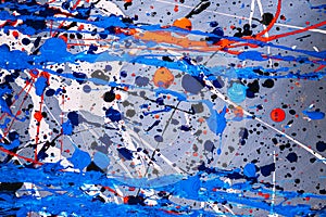 Picture painted using the technique of dripping. Mixing different colors blue red white black. A riot of color. Lines and spots.