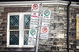 Typical North American no parking signs with detailed instructions on the parking regulations taken in Toronto, Ontario, Canada