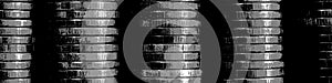 Picture with pasteurization. Stacks of coins close up. Coin texture. Black and white business header. Dark banner made of many