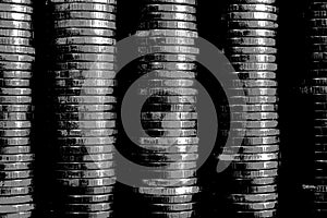 Picture with pasteurization. Stacks of coins closeup. Coin texture. Black and white business background. Dark wallpaper made of