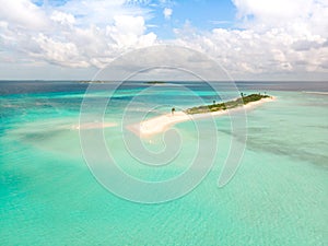 Picture perfect beach and turquoise lagoon on small tropical island on Maldives