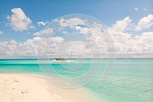 Picture perfect beach and turquoise lagoon on small tropical island on Maldives