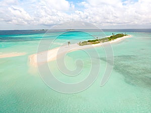 Picture perfect beach and turquoise lagoon on small tropical island on Maldives