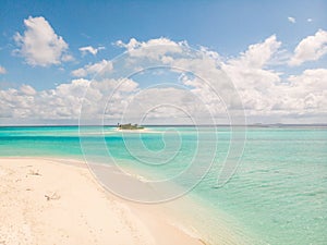 Picture perfect beach and turquoise lagoon on small tropical island on Maldives